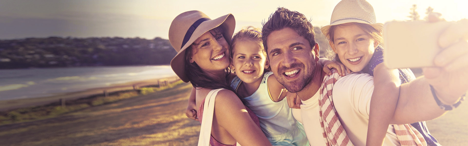 family of four on vacation taking a selfie